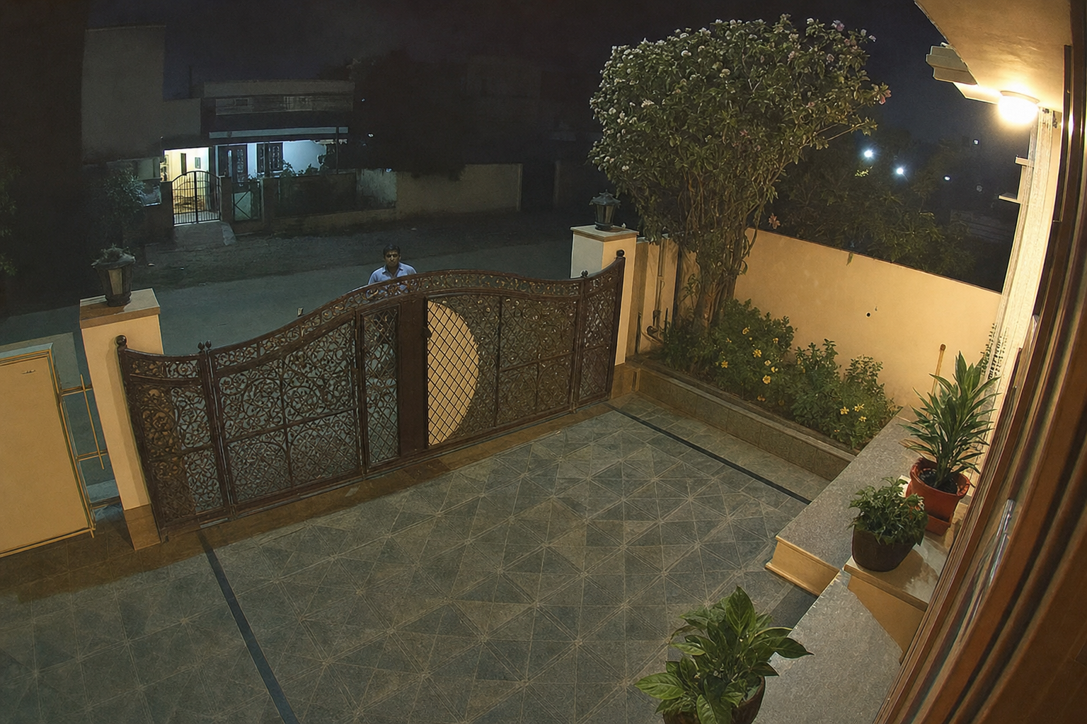 Unknown person at a residential main gate late at night